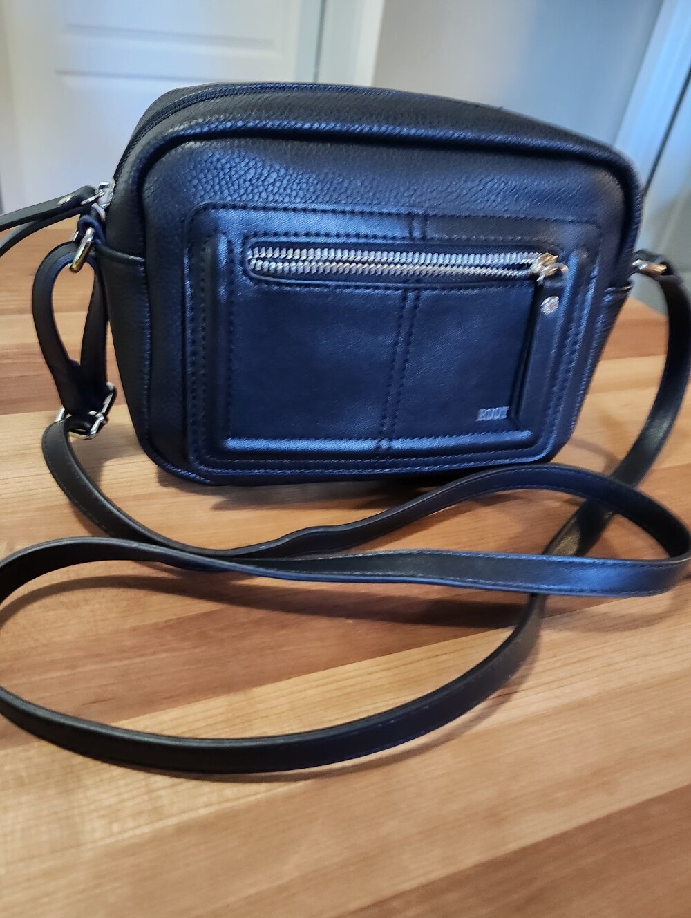 Roots Black Pebbled Vegan Leather Crossbody Bag.
